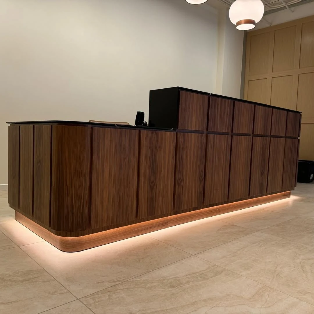 Custom wood credenza with warm LED accent lighting in a finished interior