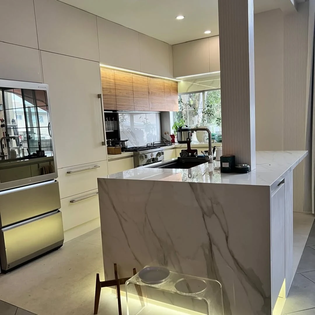Completed kitchen remodeling project with custom cabinetry and marble island